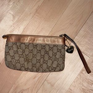 Authentic Gucci wristlet real leather accents and 6 card slots.